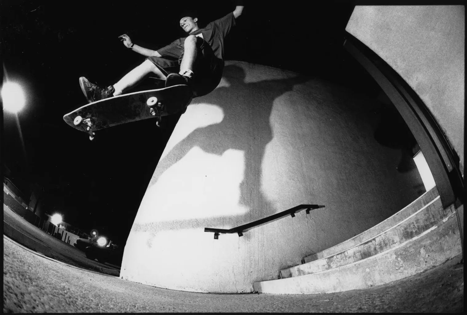 Black and white photograph of Duane Pitre performing a one-footed gap ollie